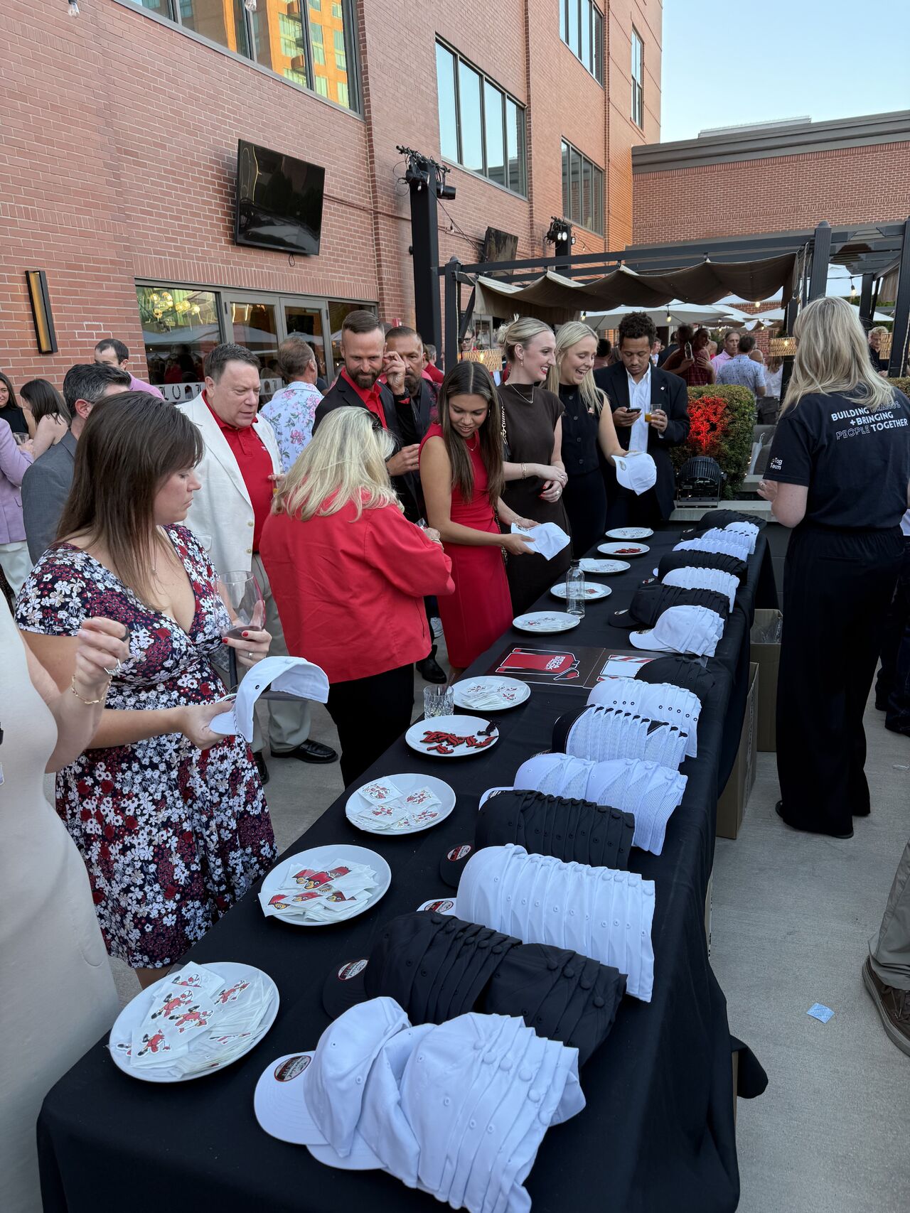 Guests choosing custom hats and patches at a #TagSwag merch table