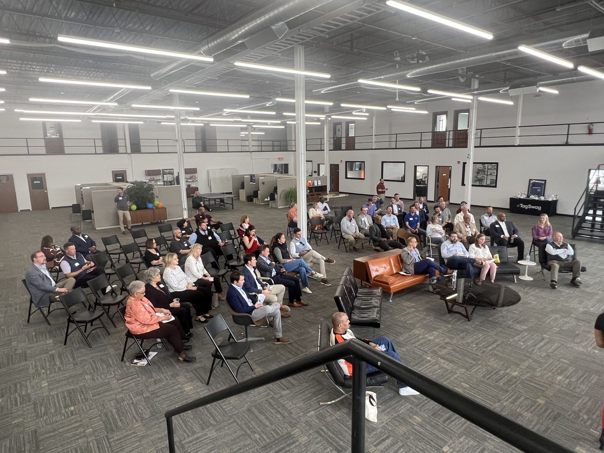 Crowd gathered for a presentation in the Swag Factory event space
