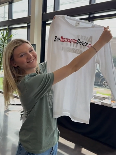 Guest holding a freshly customized tee